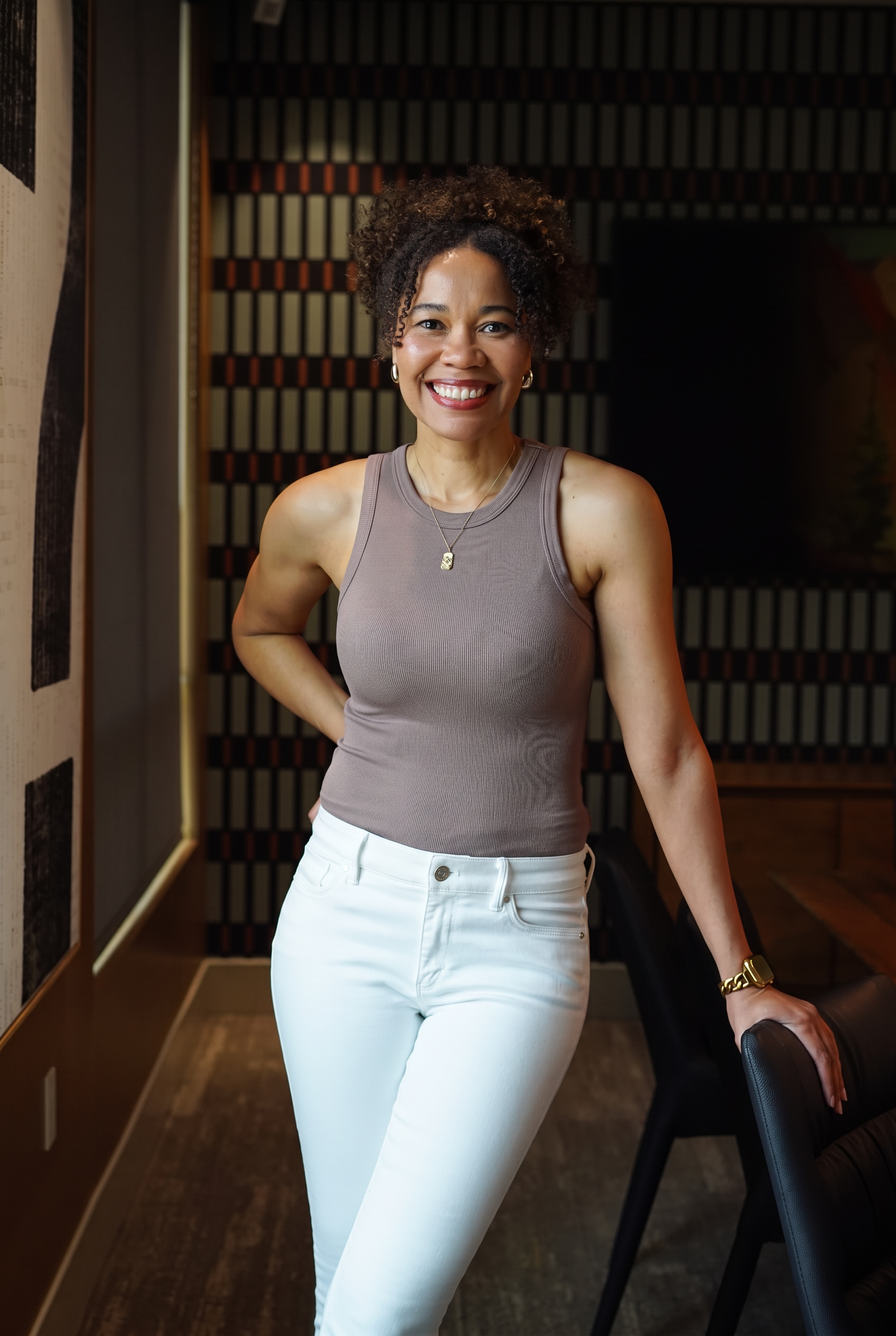 Krys Davis, founder of The Hillman Society, smiling at a table